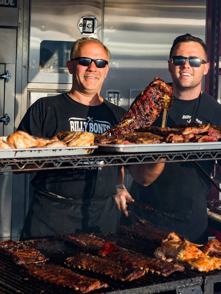 Billy Bones BBQ - Holding up rack of Ribs